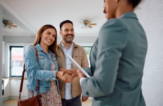 Couple being handed their keys by real estate agent