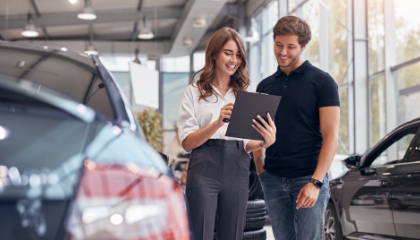 Woman sales rep at car dealership