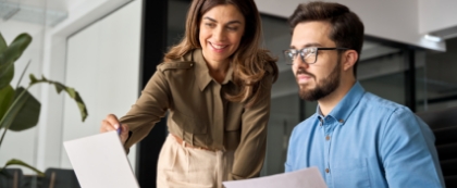 Woman and man looking at computer screen