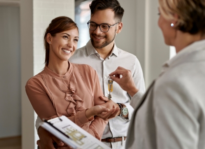 Couple getting keys from real estate agent