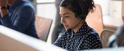 Woman telemarketer looking at computer